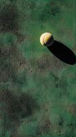 A tennis ball on a green surface photo