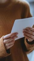 A woman holding a piece of paper in her hands photo