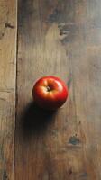 A tomato on a wooden table photo