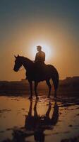 A man riding a horse at sunset photo