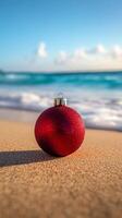 A red christmas ornament on the beach photo