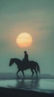 Silhouette of a man riding a horse on the beach at sunset photo