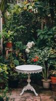 A white table in a garden surrounded by plants photo