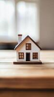 A small house sits on a wooden table photo