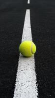 A tennis ball on the road photo