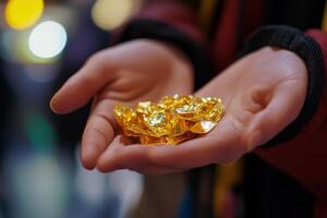 A person holding a handful of gold nuggets photo