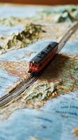 A toy train on a map photo