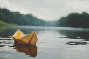 A paper boat floating in the water photo