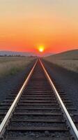 A railroad track is shown at sunset photo