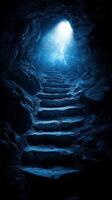 A dark cave with stairs leading to a light at the end photo