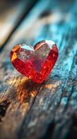 A red diamond heart on a wooden table photo