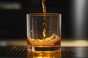 A glass of whiskey being poured into it photo