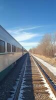 A train on the tracks with a blue sky photo