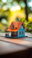 A small house sitting on a wooden table photo