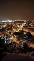 A city lit up at night with snow on the ground photo