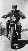 A man on a motorcycle is speeding down the road photo
