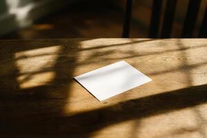 A white envelope sitting on a wooden table photo