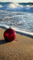 A red christmas ornament on the beach photo