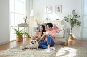 Couple Enjoys Together With Their Pet Dog in a Bright Living Room photo