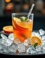 Refreshing citrus drink served with ice, garnished with mint leaves and orange slices in a vibrant setting photo