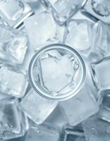 Ice cubes surround a glass with a heart-shaped ice piece resting on top in a cool setting photo