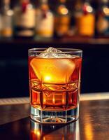 Elegant whiskey cocktail with ice in glass on a bar counter during evening hours photo