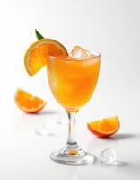 Fresh orange cocktail served in a glass with ice on a minimalistic white background photo