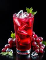 Refreshing red beverage with ice and grapes presented on a dark surface photo