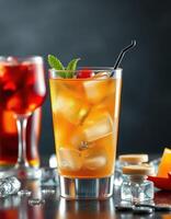 Fresh cocktail garnished with mint and cherry in a stylish glass with ice, served among other drinks on a dark background photo
