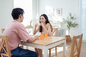 Couple Enjoys a Cheerful Breakfast at a Bright, Modern Dining Table in a Cozy Home Setting photo