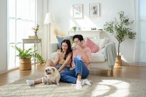 Couple Enjoys Together With Their Pet Dog in a Bright Living Room Setting photo