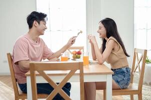 Couple Enjoys Cheerful Breakfast at a Bright, Modern Dining Table in a Cozy Home Setting photo