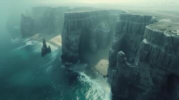 A large cliff with a beach and birds flying above it photo