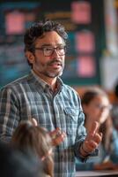 A man in glasses is speaking to a group of students photo