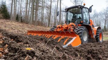 Orange Tractor Working in Field photo