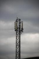 A cell phone tower with two antennas on top photo