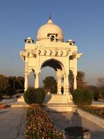 A white building with a gazebo in front of it photo