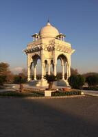 A white gazebo in the middle of a park photo