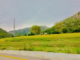A view of a road with a hill in the background photo