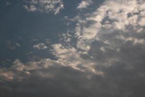 A plane flying in the sky with a cloud in the background photo