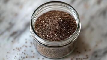 Ground Black Pepper in a Glass Jar photo