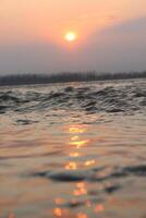 A person on a surfboard is in the water photo