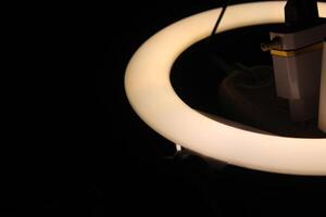 A ring light with a light bulb and a cord photo