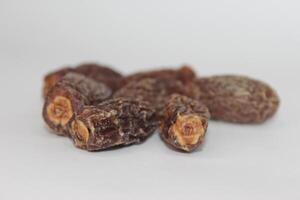 A close up of dried dates on a white background photo