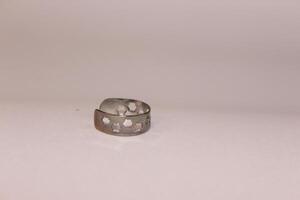 A silver ring with holes on it photo