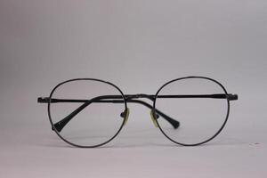 A pair of glasses with a black rim photo