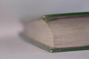 A close up of a book with a green cover photo