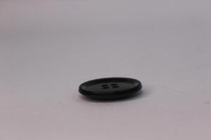A black button on a white surface photo