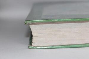 A green book with a white cover photo