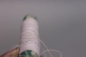 A person holding a thread photo